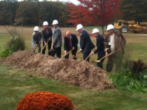 Individuals in business suits with hard hats and shovels in hand breaking ground at Kalahari Resorts & Convention Center African-themed waterpark and convention center