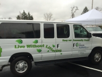 Passenger side view of a van with the Waste Authority logo and a saying "Live Without Littering" across the doors