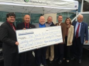 A large check worth more than $66,000 is presented to the Waste Authority