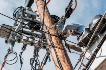 Image of electrical pole with wires as seen from below