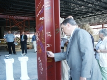 Chuck Leonard, PMEDC Executive Director, signs the beam at the Topping Off Ceremony on May 15, 2009.