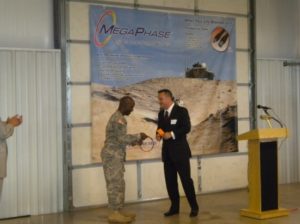 Bill Pote of MegaPhase presents the 100,000th cable to Major Corey Hemingway of the United States Army.
