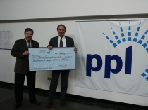 Paul Canevari of PPL presents PMEDC Executive Director, Chuck Leonard, with a Blue Ribbon Marketing Grant of $10,000