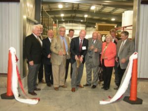 Keith Hayward, MNW Managing Director, cuts the “non-woven” ribbon to officially open the latest 7,500 square foot expansion at the Mount Pocono facility as community leaders look on.