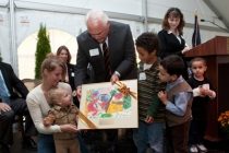 Chuck Hannig (center), president of Spread Eagle Associates, admires pictures of what the children in the Hannig Family Children’s Center envision the new campus will look like