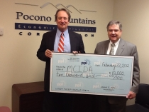 Paul Canevari of PPL Electric Utilities presents a check for $10,000 to Chuck Leonard, PMEDC Executive Director