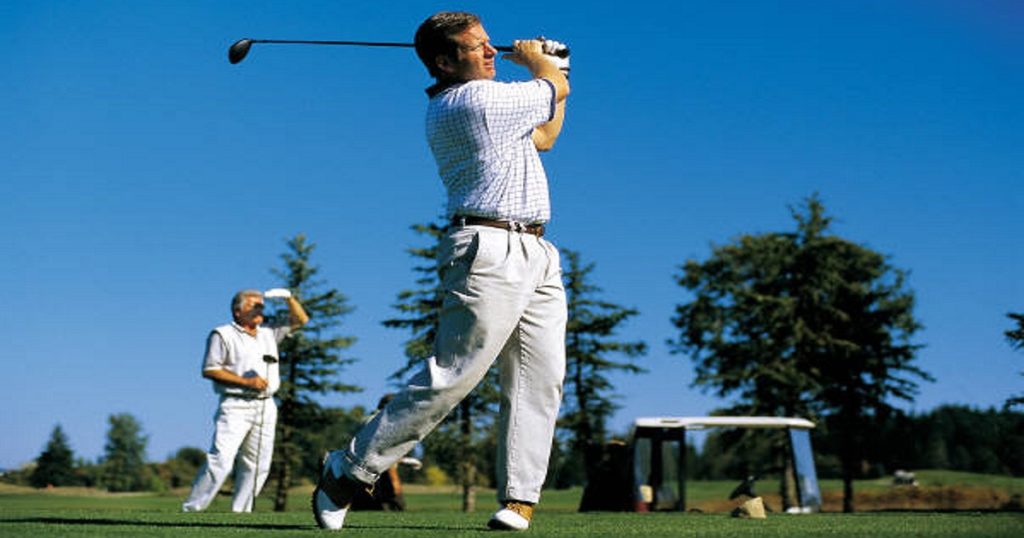 Two men golfing on a green course